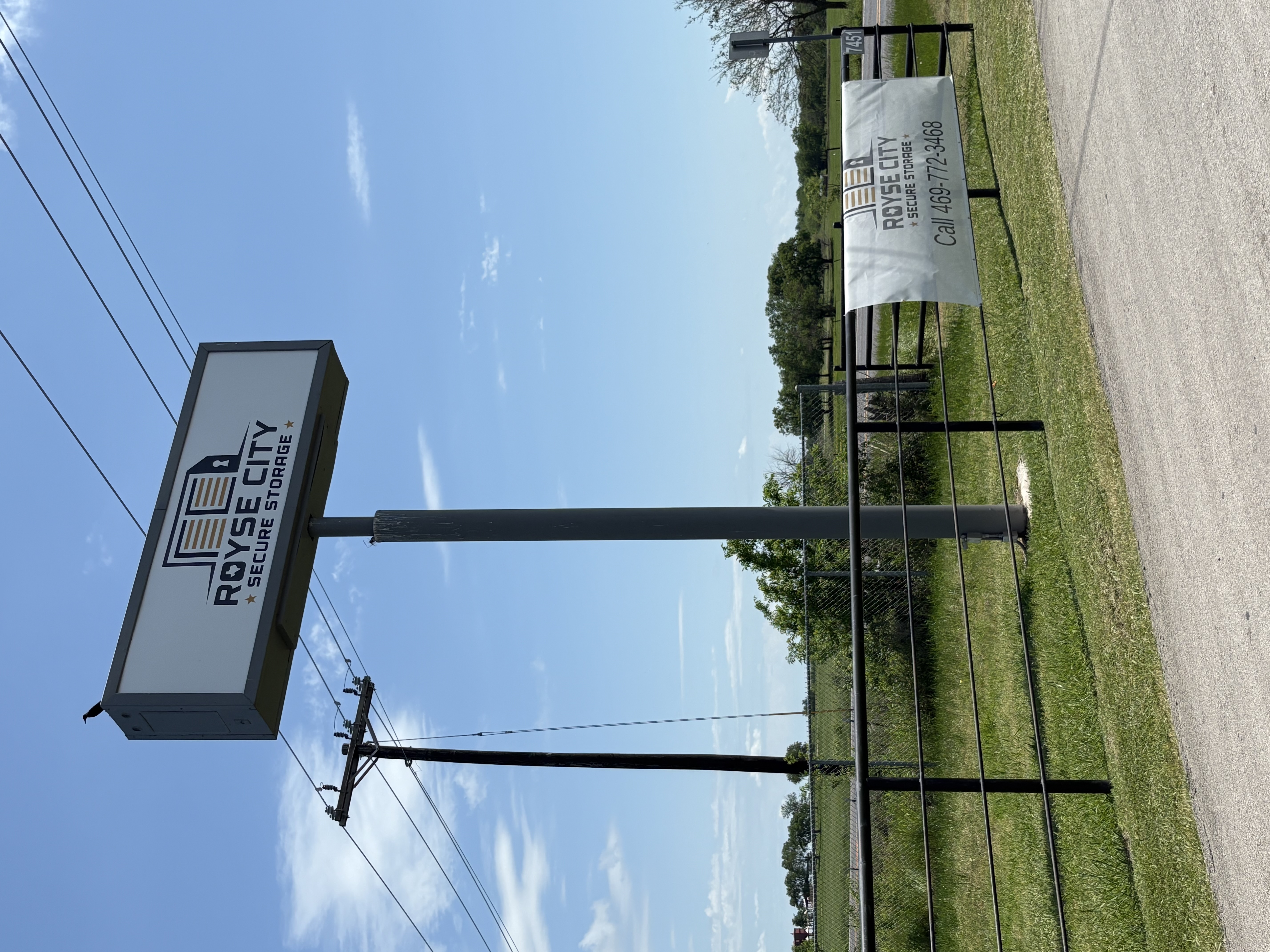Royse City Secure Storage roadside sign and entrance banner with contact phone number at 7451 FM 35, located near Rockwall, Fate, and Caddo Mills, TX.